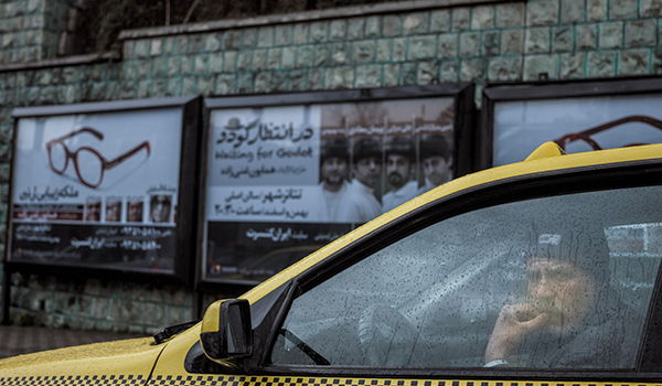| A taxi driver in his car on a rainy day in Iran | MR Online