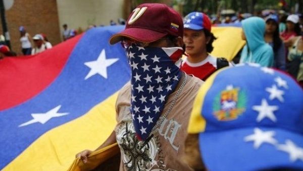 | A Venezuelan opposition protester wears a US flag bandanna around his face | MR Online