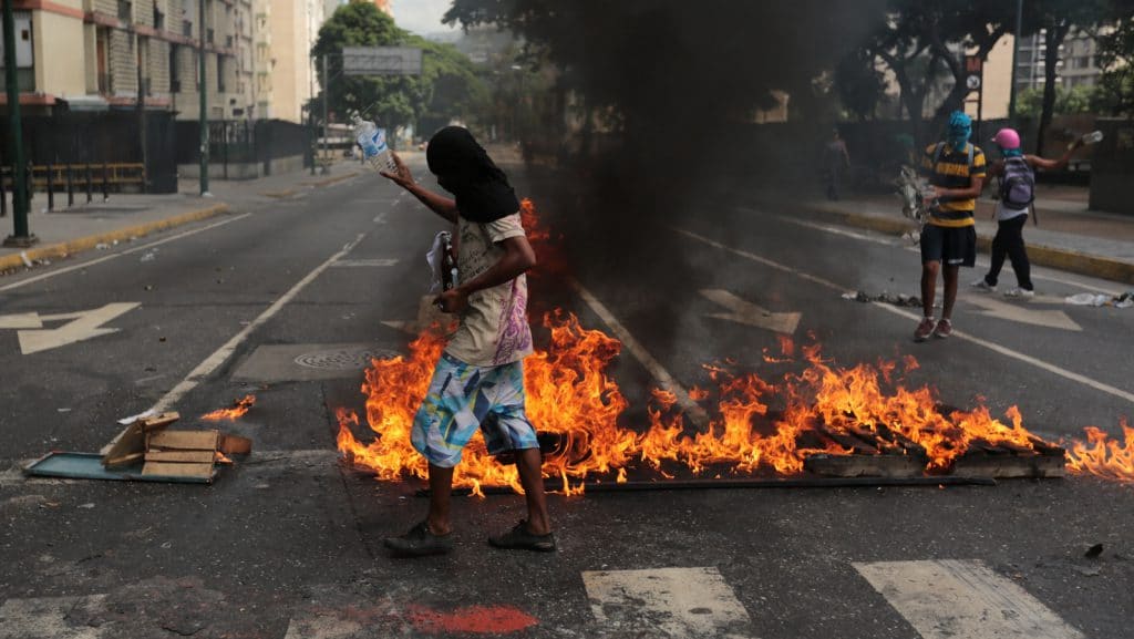 | Anti government protesters oversee a burning barricade in Caracas Venezuela Monday June 26 2017 Protesters have flooded the streets of Venezuela for months demanding new elections and faulting President Nicolas Maduro | MR Online's leadership for the country's triple-digit inflation, surging crime rates, and dire shortages of food and medicine. (AP Photo/Fernando Llano)