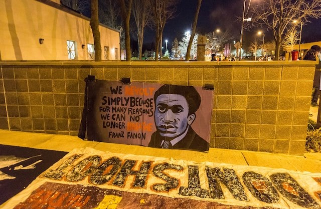 | Fanon Banner outside the Minneapolis Police Department fourth precinct following the officer involved shooting of Jamar Clark on November 15 2015 Photo Tony Webster tonytonywebstercom | MR Online