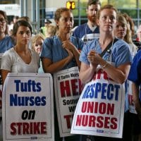 Nurses and supporters listen to speakers during the nurses strike outside Tufts Medical Center, Wednesday, July 12, 2017. Staff photo by Angela Rowlings.