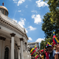 Chavistas gathered around Venezuela's Legislative Palace to witness the return of Simón Bolívar and Hugo Chávez' portraits