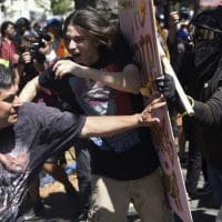 Anti-fascists push back against a fascist protestor with a Pinochet T-shirt