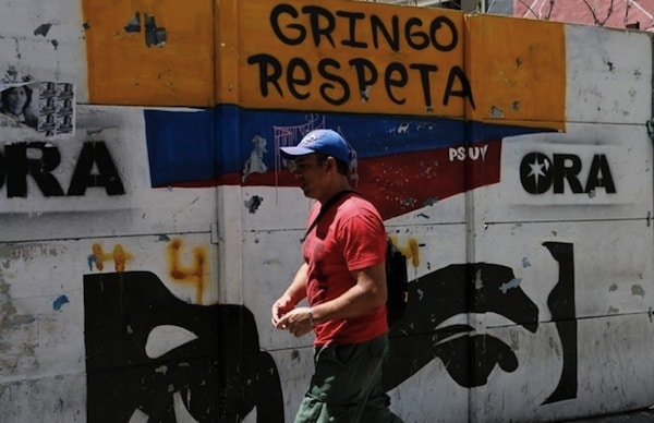 | A man walks past a graffiti in Caracas Venezuela August 13 2017 | MR Online