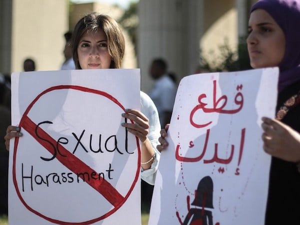 | Ladies holding signs against sexual harassment | MR Online