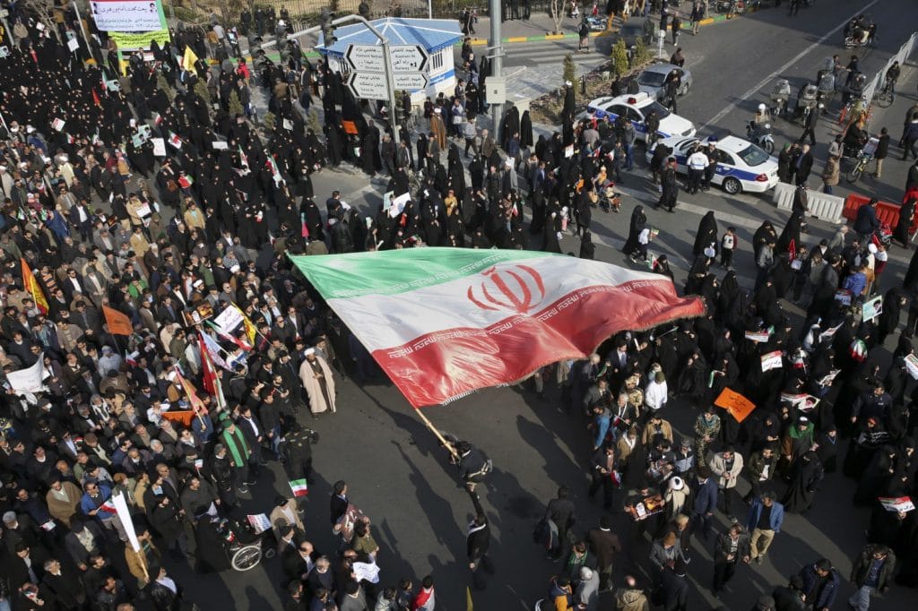 | A demonstrator waves a huge Iranian flag during a pro government rally | MR Online