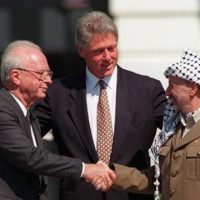 Israeli prime minister Yitzhak Rabin (L), PLO chairman Yasser Arafat (R) and US president Bill Clinton at the ceremony marking the signing of the 1993 peace accord