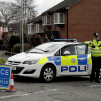Police officers stand guard at the bottom of the road where former Russian double agent Sergei Skripal lives in Salisbury, England