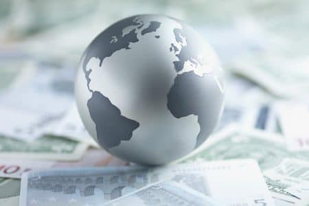 | Metal globe resting on paper currency | MR Online