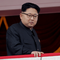 North Korean leader Kim Jong Un watches parade.