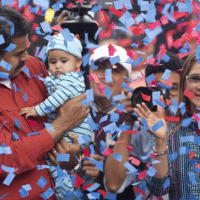 Venezuela's President Nicolas Maduro holds a baby as first lady Cilia Flores (right) applauds during a campaign rally in the parish of Catia in Caracas, Venezuela, last Friday