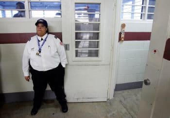 | A guard holds open a door during a media tour | MR Online