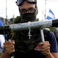A demonstrator holds a homemade mortar during a protest against the government of Nicaragua's President Daniel Ortega, in Managua, Nicaragua June 17 2018.