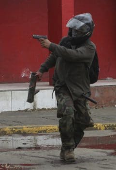 | A man aims a pistol at police in during clashes in Masaya Nicaragua on Saturday | MR Online