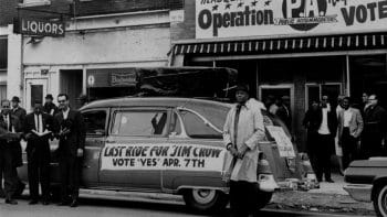 | A sign reading Last ride for Jim Crow in front of the headquarters of workers who pushed to overturn a discriminatory Kansas City ordinance by referendum April 7 1964 AP Photo | MR Online