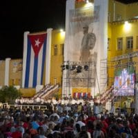 People attend an event celebrating Revolution Day in Santiago, Cuba, today