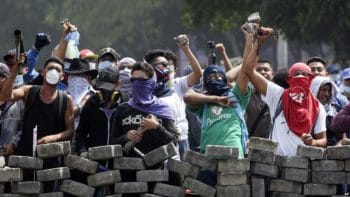 | Protesters yell from behind the roadblock they erected as they face off with security forces near the University Politecnica de Nicaragua in Managua Nicaragua April 21 2018 Source Voice of America | MR Online