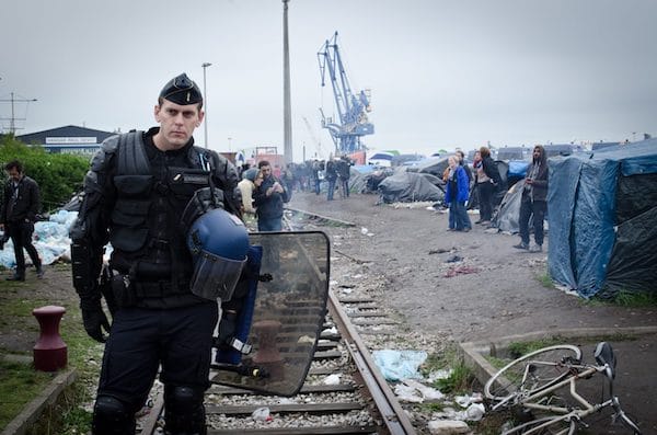 | An armed police officer at Calais migrant camp Photo by Squat le Monde Photo Credit Flickr | MR Online