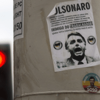 A sticker calling presidential candidate Jair Bolsonaro as an ‘Enemy of the worker’ covers a street column in Rio de Janeiro, Brazil (Photo Credit: Morning Star)