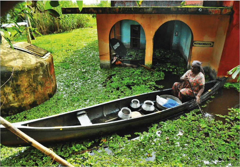 | Woman transporting utensils from her flooded house at Kainakari panchayat | MR Online