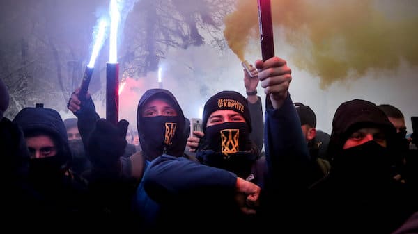 | Volunteers with the right wing paramilitary Azov National Corps light flares during a rally on the snowy streets in front of the Ukrainian parliament in Kiev Ukraine Nov 26 2018 Protesters from far right party National Corps brandished yellow and blue flags with the Ukrainian national trident symbol and a banner reading Dont back down Efrem Lukatsky | AP | MR Online
