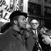At a rally outside the U.S. Courthouse October 29, 1969, Dr. Benjamin Spock, background, listens to Fred Hampton, chairman of the Illinois Black Panther party. It was part of a protest against the trial of eight persons accused of conspiracy to cause a riot during the Democratic National Convention in 1968. Photo: AP Photo