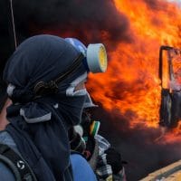 Demonstrators set a truck on fire in Caracas, Venezuela (February 18, 2018)