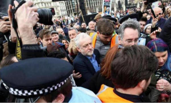 | Movement activists including John Rees help Jeremy Corbyn back to his car after he spoke at the national demonstration for the NHS on March 6 2017 Photo Taj Ali | MR Online
