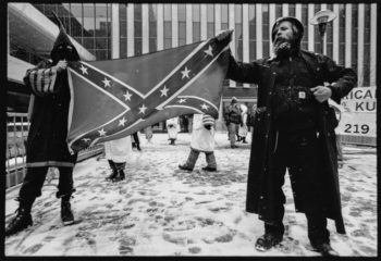 | Two men holding Confederate flag © Jon Hughes | MR Online