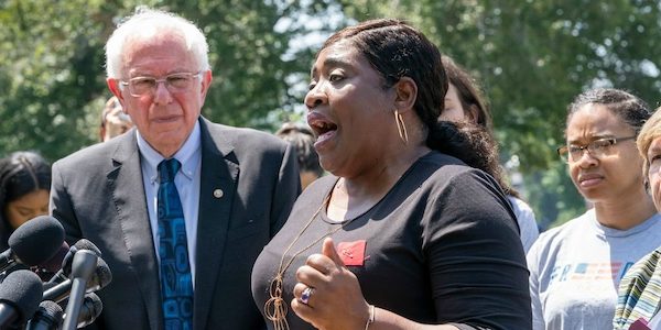 | New York Times depiction 72419 of Bernie Sanders at a student debt rally with indebted former student Pamela Hunt Photo J Scott ApplewhiteAP | MR Online