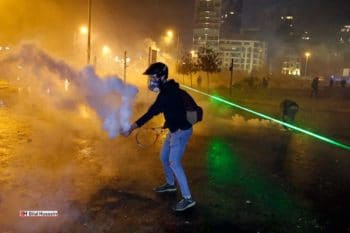 | An anti government protester throwing back a tear gas canister | MR Online