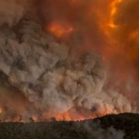 Wildfires rage under plumes of smoke in Bairnsdale, Australia. (Glen Morey via AP)