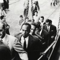 Frantz Fanon walking up a ship gangway. To Fanon’s right is Rheda Malek, a journalist from the Algerian National Liberation Front newspaper El Moudjahid. . Frantz Fanon Archives / IMEC