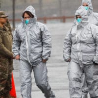 Medical personnel arrive to perform COVID-19 coronavirus infection testing procedures at Glen Island Park, Friday, March 13, 2020, in New Rochelle, N.Y. (AP Photo/John Minchillo)