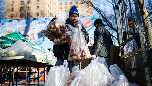 | A volunteer wearing protective gloves organizes pre bagged food donations at a City Harvests Bed Stuy Mobile Market operating in the Tomkins Houses area Wednesday March 18 2020 in New York Mayor Bill de Blasio said New York City residents should be prepared for the possibility of a shelter in place order within days De Blasio said Tuesday no decision had been made yet but he wants city and state officials to make a decision within 48 hours given given the fast spread of the coronavirus AP PhotoJohn Minchillo | MR Online
