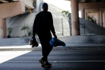| A volunteer delivers tents and meals to the homeless during the coronavirus pandemic in Miami Florida April 3 2020 Lynne Sladky | AP | MR Online