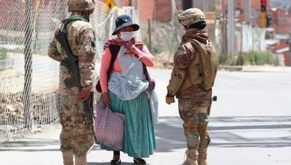| Soldiers question an indigenous woman on the way to buy food Photo TeleSUR | MR Online