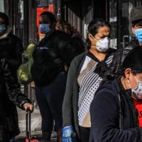 Women in Brooklyn’s Sunset Park, a neighborhood with one of the city’s largest Mexican and Hispanic community, wear masks to help stop the spread of coronavirus while waiting in line to enter a store, May 5, 2020, in New York. Bebeto Matthews | AP