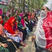 Bangladeshi garment workers block a road demanding their unpaid wages during a protest in Dhaka, Bangladesh, April 16, 2020. Credit: AP Photo/Al-emrun Garjon
