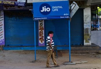 | A man walks past a Reliance Jio signage in front of a closed shop in Hyderabad India Wednesday April 22 2020 Facebook says it plans to invest  billion in Indias telecom giant Reliance Jio The investment will give Facebook a 999 stake in Jio Platforms the digital technologies and app developing division of Reliance Industries AP PhotoMahesh Kumar A | MR Online