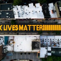 A giant “BLACK LIVES MATTER” sign is painted in orange on Fulton Street, June 15, 2020, in Brooklyn, New York. John Minchillo | AP