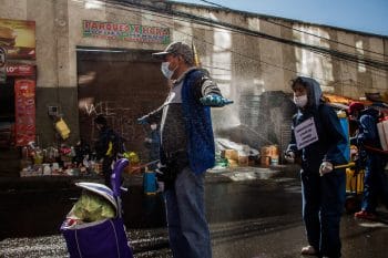 | Shoppers at the market pay to be disinfected Rodríguez Market La Paz Bolivia 2020 Carlos Fiengo | MR Online