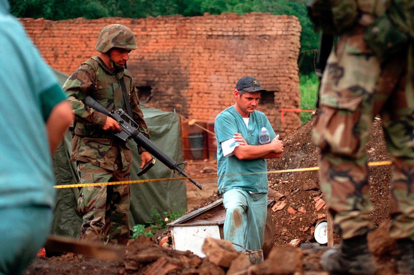 | US Marines provide security as members of the Royal Canadian Mounted Police Forensics Team investigate a grave site in a village in Kosovo on July 1 1999 | MR Online
