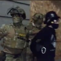 Unidentified, unmarked officers in military gear arresting a protestor in Portland, OR on July 16, 2020