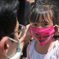 | A father helps his child with a mask in front of Bradford School in Jersey City New Jersey on June 10 2020 AP PhotoSeth Wenig File | MR Online