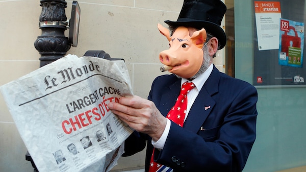 | An activist displays a newspaper headlining the Panama Papers revelations during a banking managers meeting in Paris France Francois Mori | AP | MR Online