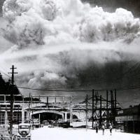 The bombing of Nagasaki as seen from the town of Koyagi, about 13 km south, taken 15 minutes after the bomb exploded. In the foreground, life seemingly went on unaffected. (Wikipedia)