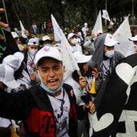 Ex-combatants of the disbanded FARC and social activists march to demand the government guarantee their right to life and compliance with the 2016 peace agreement, in Bogota, Colombia, Nov. 1, 2020. Fernando Vergara | AP