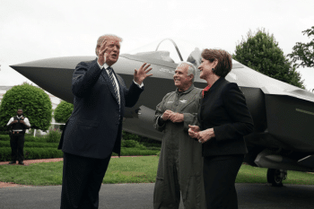 | President Donald Trump talks to Chairman President and CEO of Lockheed Martin Marilyn Hewson and Director and Chief Test Pilot Alan Norman in front of an F 35 fighter jet in 2018 Source politicocom | MR Online