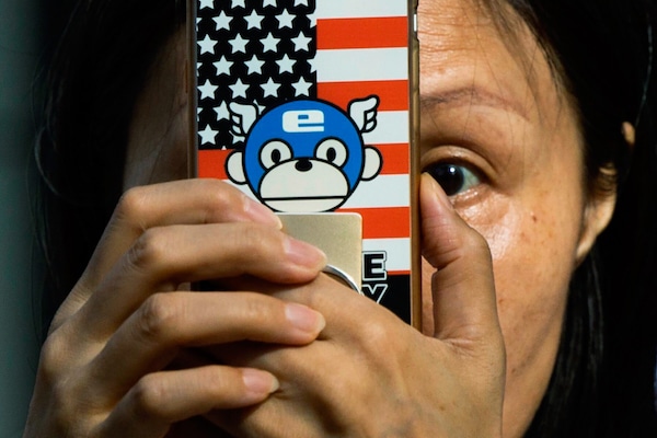 | A woman takes a photo with a phone that has a United States flag themed cover outside the United States Consulate in Chengdu in southwest Chinas Sichuan province on July 26 2020 Ng Han Guan | AP | MR Online